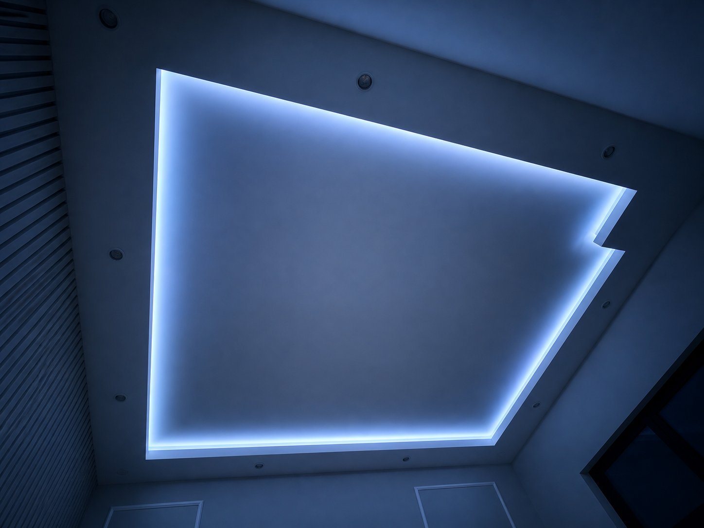 Ceiling with blue neon trim lighting forming a rectangular frame outline